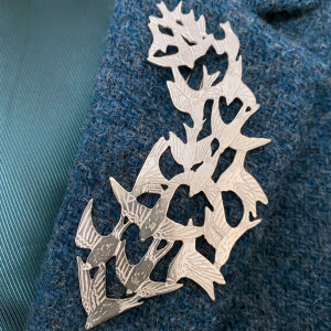 a handmade sterling silver pendant of a flock of starlings in flight, murmuration collection, saw pierced, hand engraved, statement piece, made in glasgow scotland