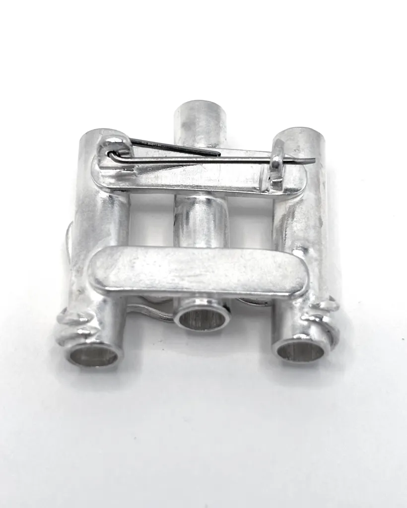 Back of a handmade sterling silver brooch showing the pin fastening and the open ends of three tube vases