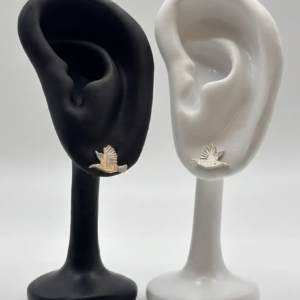 A single sterling silver starling stud earring, an engraved bird in flight, shown on black and white display ears