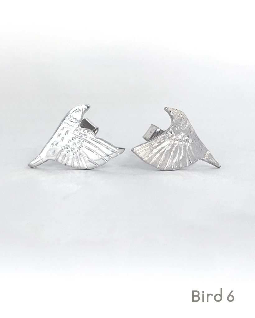 Sterling silver starling stud earrings, Bird 6 design, an engraved starling with wings raised high, on white