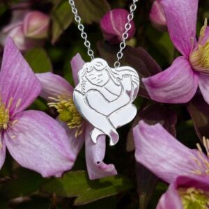 Handmade sterling silver self love pendant shaped like a figure hugging itself, hand engraved, styled with flowers