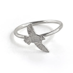 Single sterling silver bird ring on a slim band, an engraved bird diving with wings swept down, on white