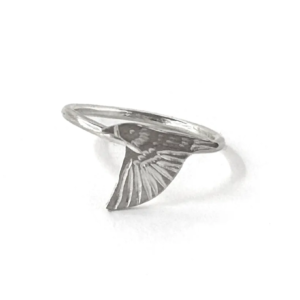 Single sterling silver starling ring on a slim band, an engraved starling diving with wings swept down, on white