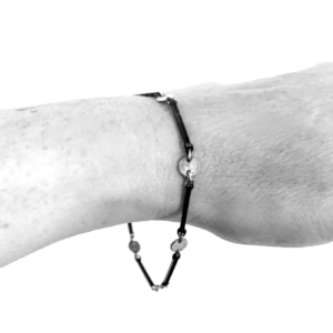 A bracelet formed of oxidised sterling silver square wire linked to shiny polished silver circles, and closed with a sterling silver lobster clasp