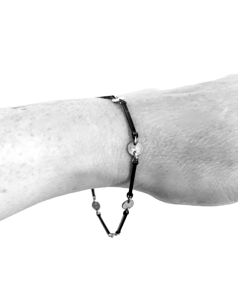 A bracelet formed of oxidised sterling silver square wire linked to shiny polished silver circles, and closed with a sterling silver lobster clasp