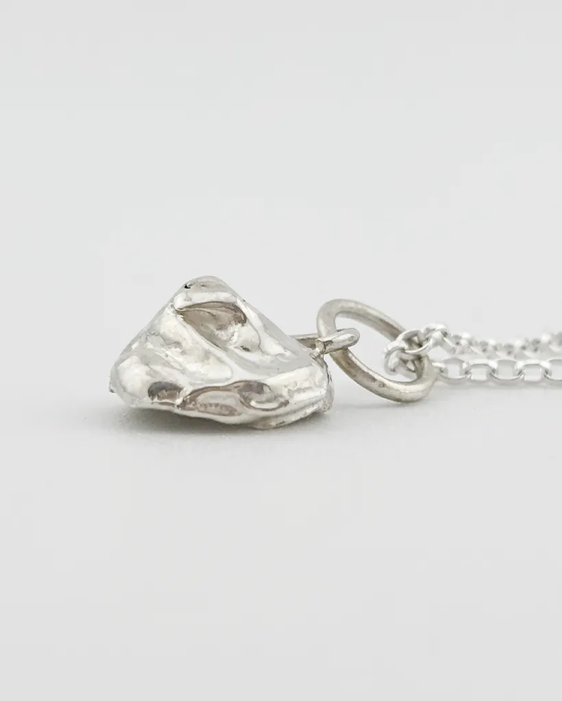 a water cast 925 sterling silver pendant in the shape of a birds nest with eggs