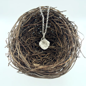 a water cast 925 sterling silver pendant in the shape of a birds nest with eggs