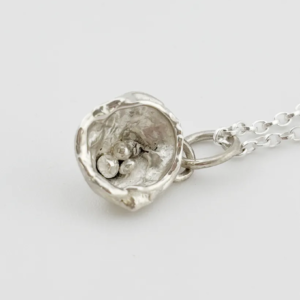 a water cast 925 sterling silver pendant in the shape of a birds nest with eggs