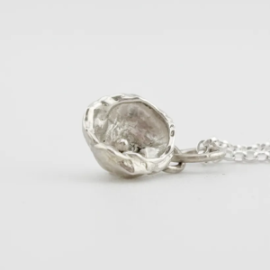 a water cast 925 sterling silver pendant in the shape of a birds nest with eggs