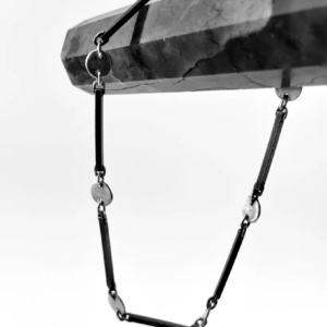 Oxidised sterling silver dot and dash chain draped over a dark crystal point, bar links joined to silver circles