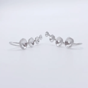 Front view of 925 sterling silver ear climber earrings, showing a mirrored pair with domed dots cascading in a gentle curve from large to small.