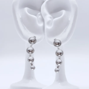 a pair of sterling silver ear climber earrings with four cascading domed silver dots from small to large. Rotated, in this case, to dangle nicely downward from the ear