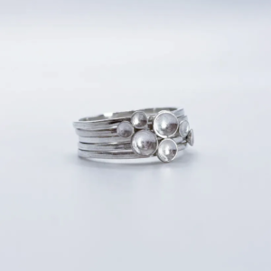 Polished sterling silver Murmuration Dot stacking ring set, bright silver bands with domed dots clustered as a flock