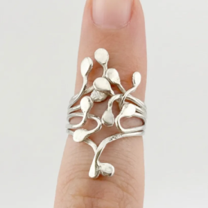 Top down view of the handmade sterling silver Squiggle ring worn on a finger, showcasing the organic climbing droplets against a clean light background.