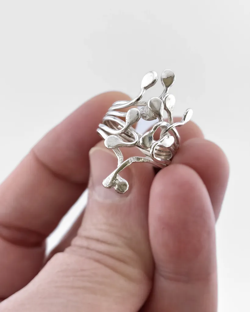 Squiggle Statement Ring in Sterling Silver | Stacy Bias Jewellery Silver Squiggle statement ring held in a hand to show scale. Sculptural artisan jewelry by Stacy Bias.