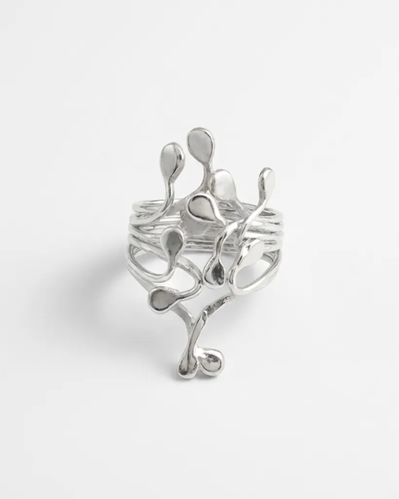 Top down studio view of sterling silver Squiggle ring with polished droplets. Handcrafted by Stacy Bias.