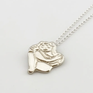 Chunky silver Self Love pendant showing a figure hugging themselves on a chain. Handcrafted by Stacy Bias.