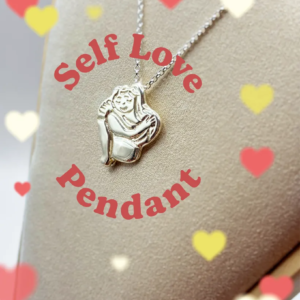 Chunky silver Self Love pendant necklace on a display bust with heart graphics and overlay text. By Stacy Bias.